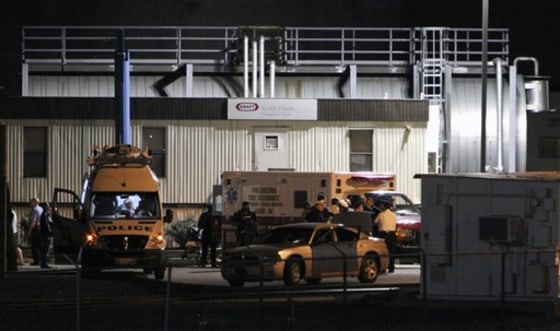 Police gather at the scene of a workplace shooting at the Kraft Foods Inc. facility in Northeast Philadelphia on Thursday.